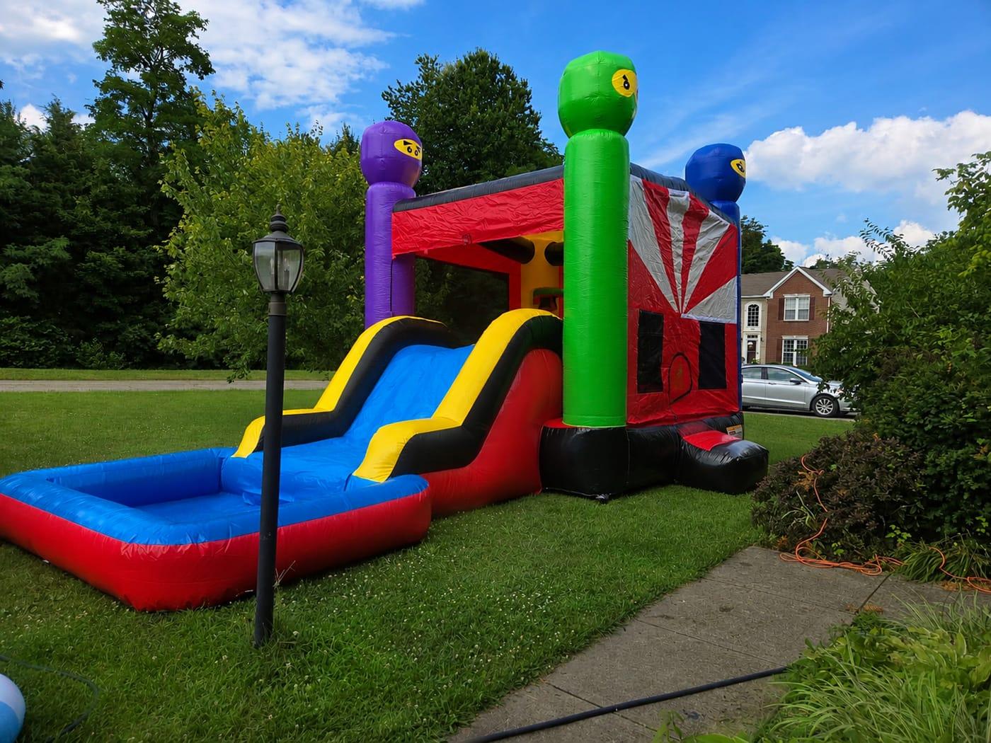 Cincy Ninja Bounce wet/dry combo with ninja towers, slide, and splash pool